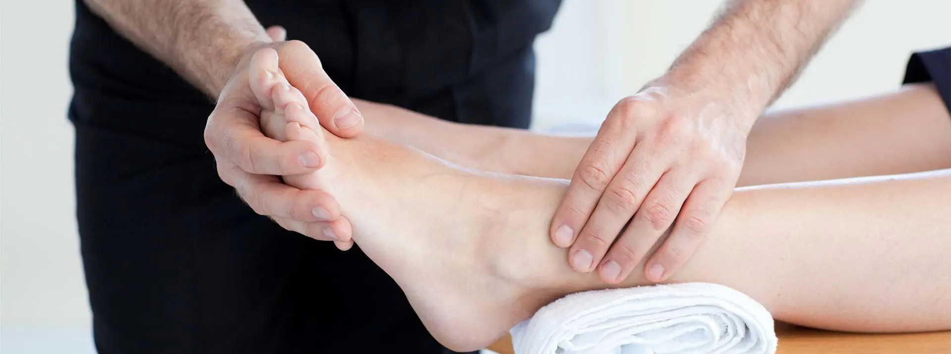 podiatrist assessing foot