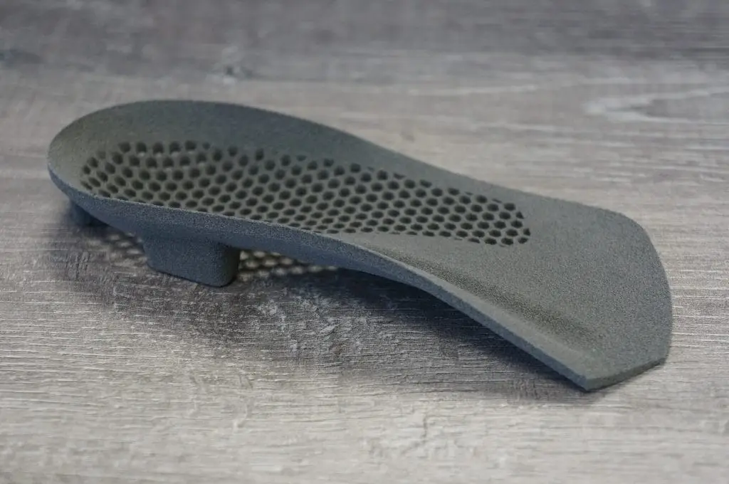 Close-up of a custom 3D printed orthotic showing the honeycomb lattice structure for lightweight support