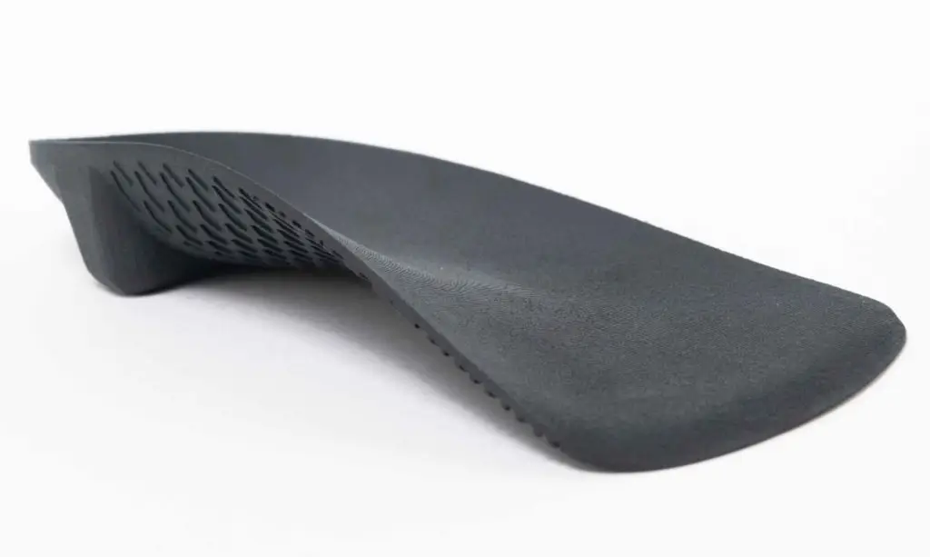 Side profile of a custom 3D printed orthotic showing arch support and heel cup